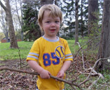 Lio carrying sticks at his grandmother's house in New Jersey